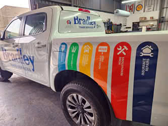 Bradley Trade Services fleet signage on utility vehicle, side view