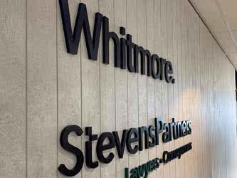 Cropped view of signage on a wall, front left view, inside office