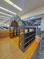An elaborate display for Red Rock Deli built as an arch that people can walk through, front-side view